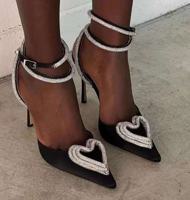Women's pink satin sandals with heart rhinestone detail and adjustable cross strap.