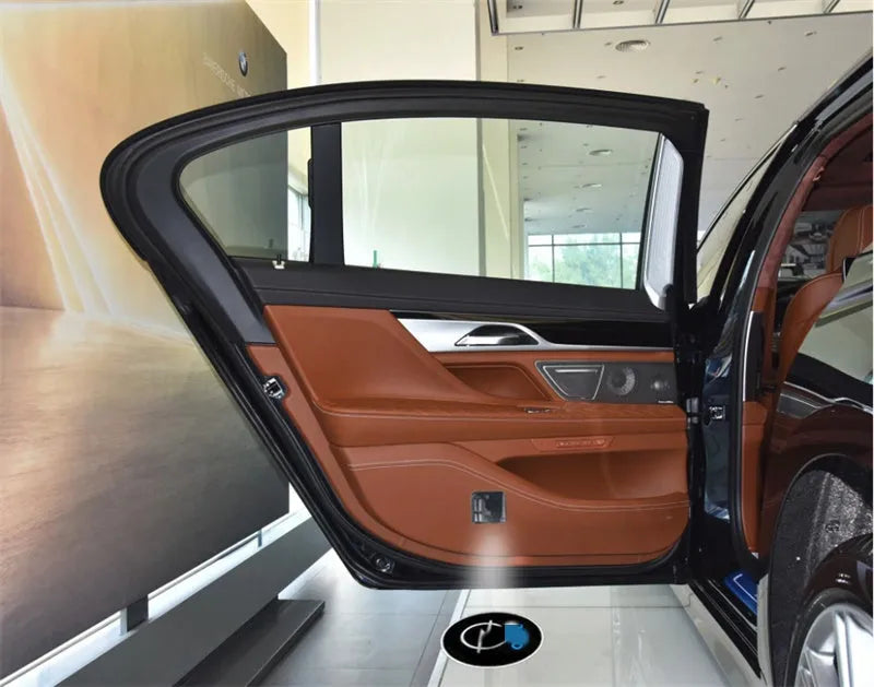 Two black wireless car LED welcome door projection lights with 3D logo display, plastic housing