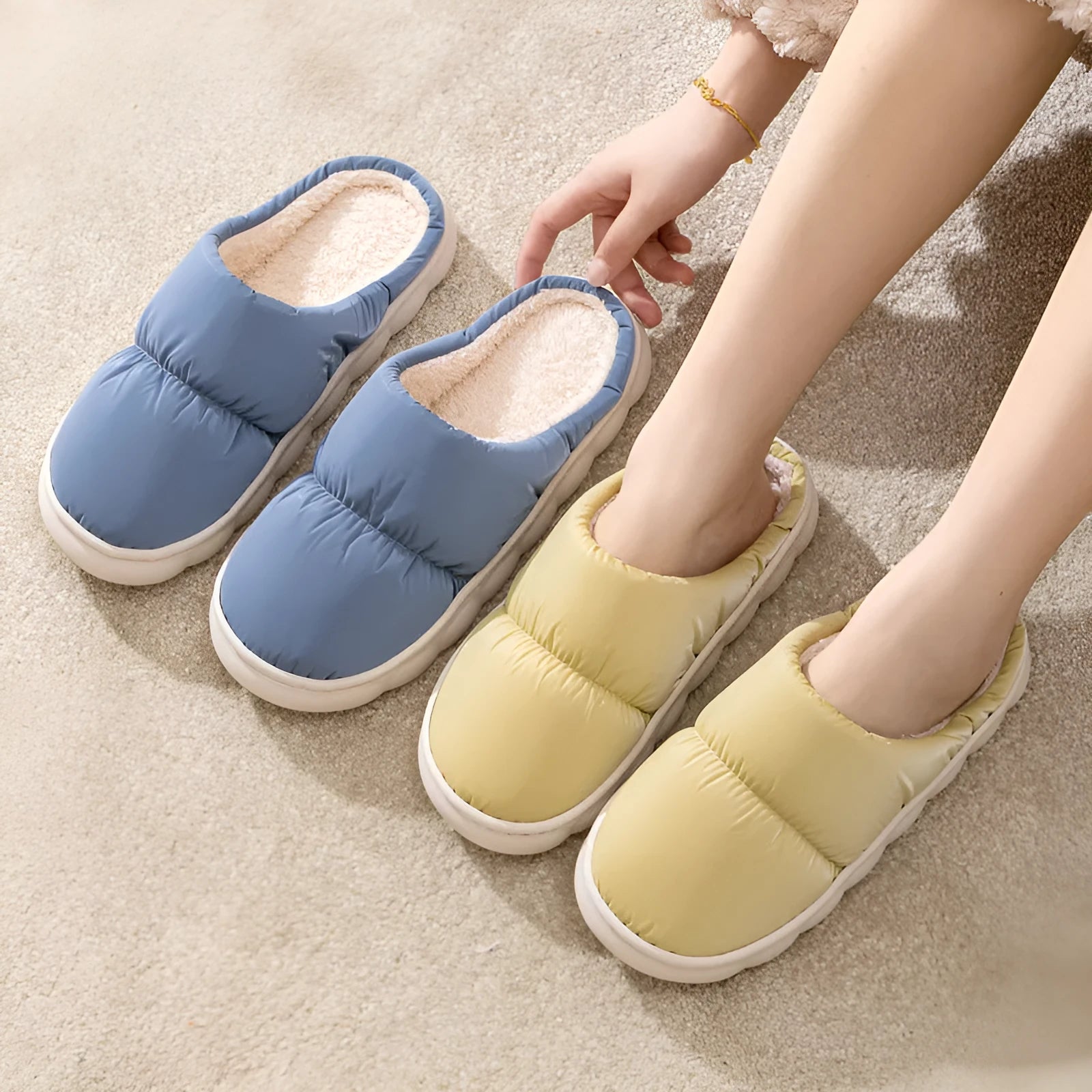 A pair of thick-soled house slippers with an artificial leather upper and plush lining, shown in a selection of colours.