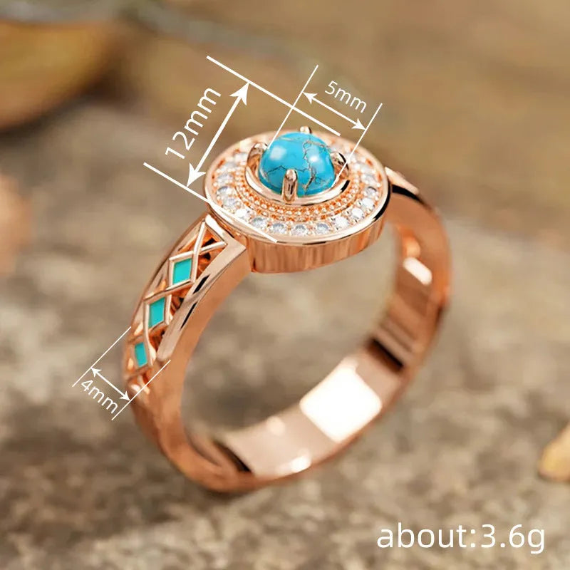 Rose gold women's ring with turquoise geometric centre and inlaid zircon stones on a finger.