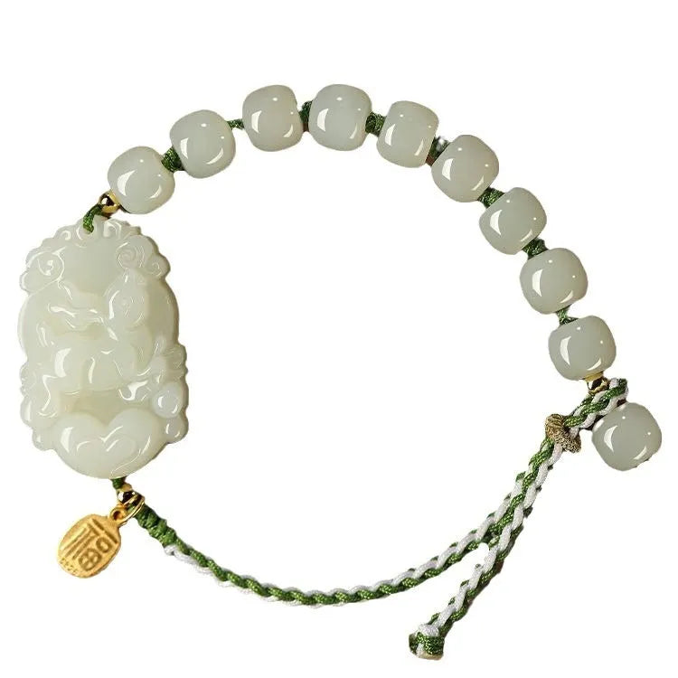 Hetian Jade Zodiac Bracelet on wrist showing rabbit charm, silver card, and red ice cotton rope.