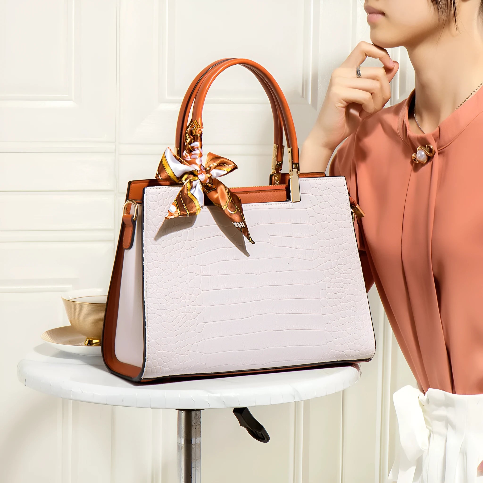 Milky white women's shoulder handbag with horizontal square shape showing internal organiser compartments