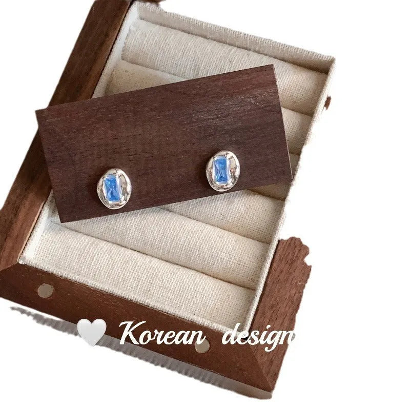 S925 sterling silver oval blue diamond heart-wrapped geometric earrings with electroplated silver finish