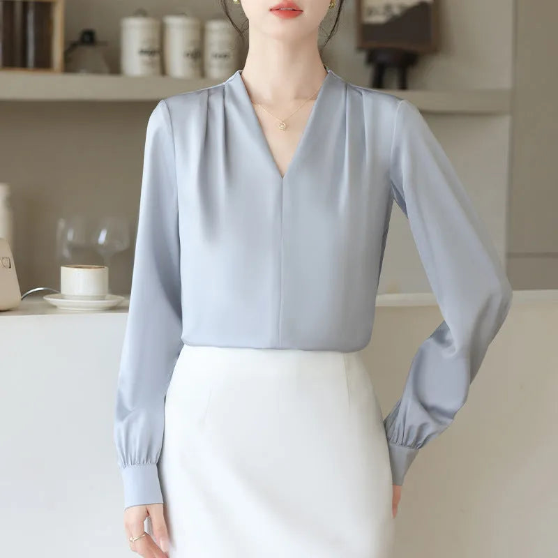 Women's blue satin shirt with long sleeves and slim fit showing 3D stitching detail