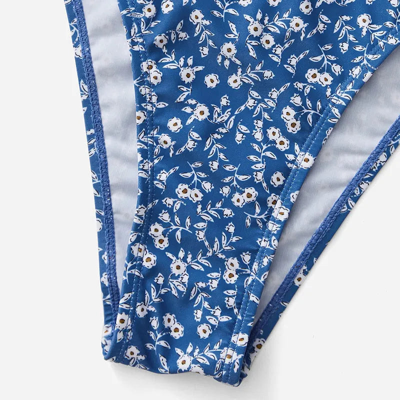 Blue polyester swimsuit three-piece set showing top and shorts for swimming.