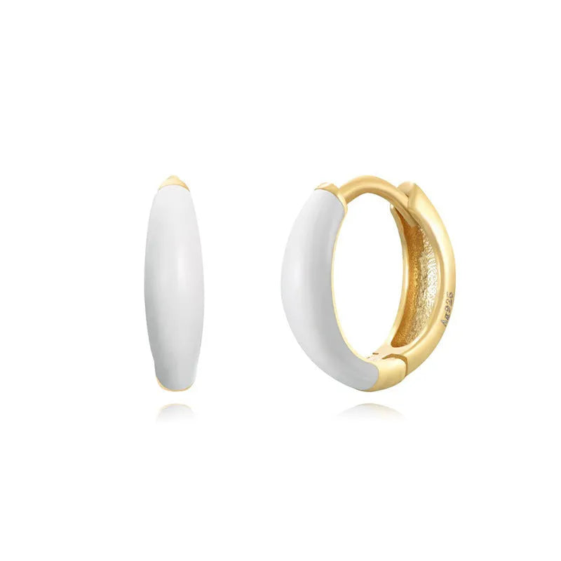 A pair of curved U-shaped epoxy earrings with a translucent blue dripped oil finish and a silver hook on a white background.