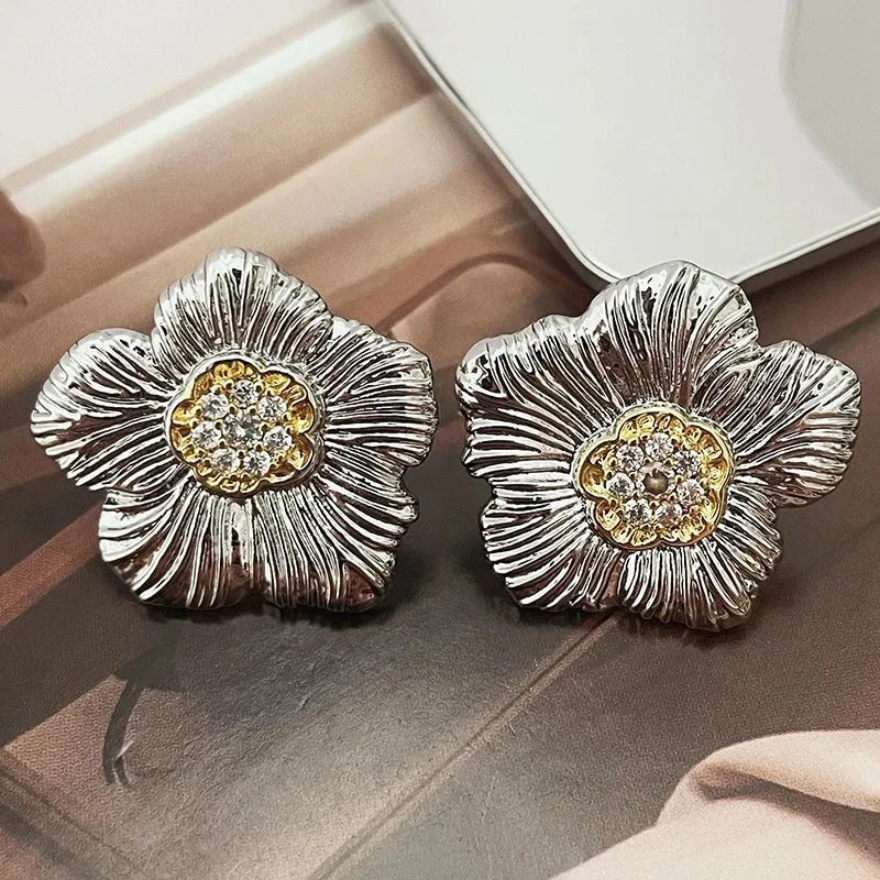 Retro copper stud earrings with a textured gardenia design in a two-tone electroplated finish.