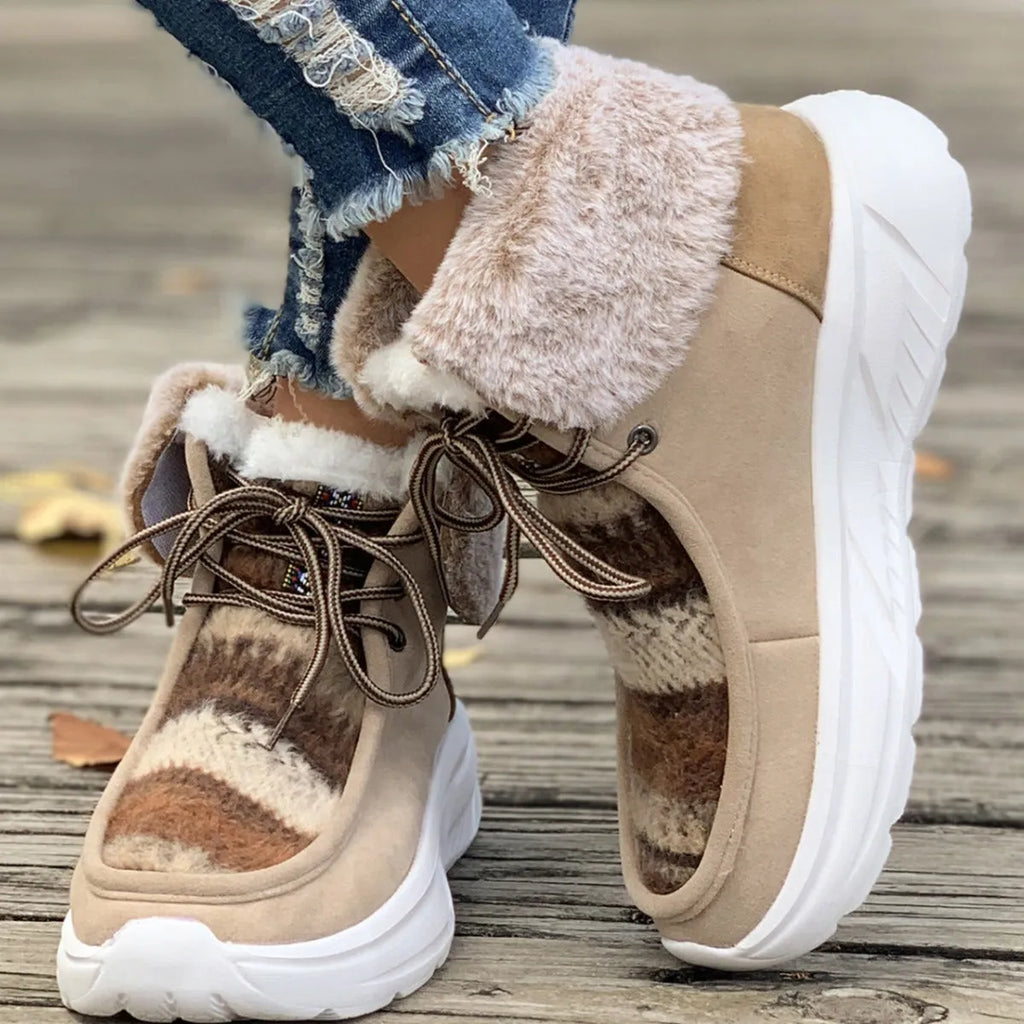 Beige women's lace-up suede snow boots with fuzzy finish and thick rubber sole.
