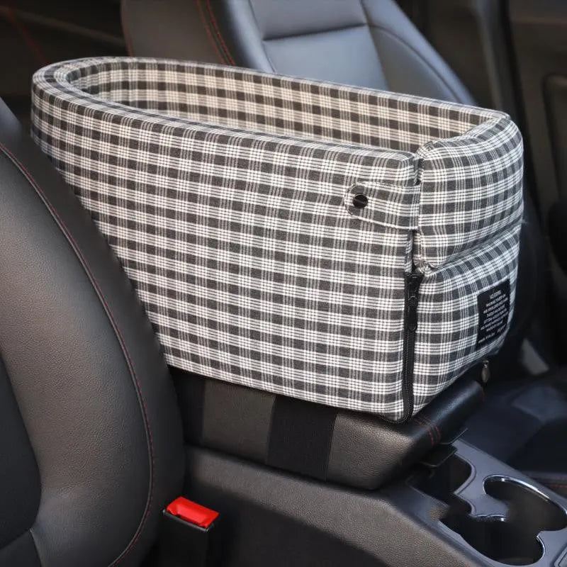 Portable pet car seat booster kennel in black grid with flip-top cover on car armrest, suitable for small dog or cat travel
