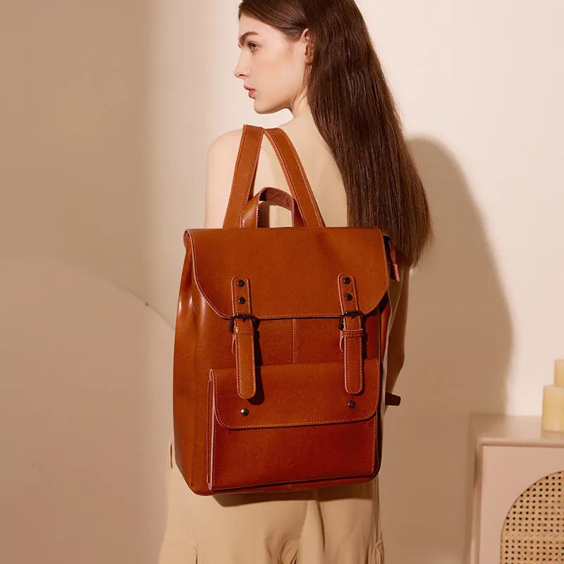 Black two-layer cowhide leather computer backpack for women with internal lining.