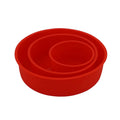 Set of three bright red round silicone cake moulds in 4-inch, 6-inch, and 8-inch sizes on a kitchen counter.