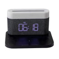 White wireless charging table lamp with integrated alarm clock on bedside table