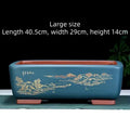 Handmade deep blue black rectangle purple clay bonsai pot on a wooden surface.