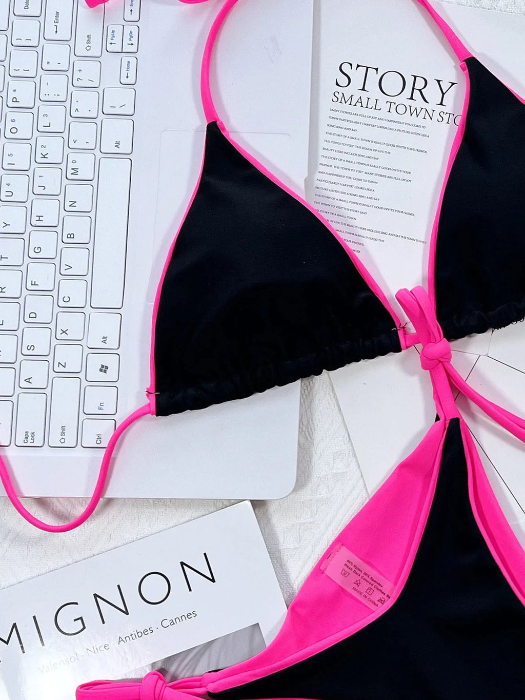 Women's black bikini swimsuit with chest pad and briefs, shown alongside pink, green, blue, and red colour options.