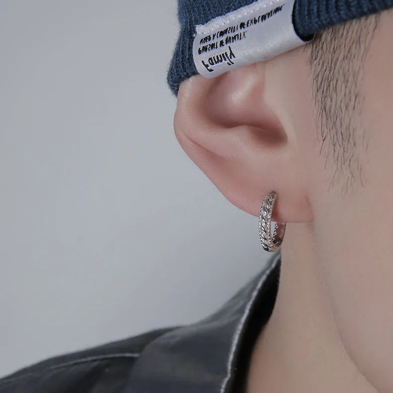West Coast men's geometric copper earring studs on a plain background, showing silver and patterned options.