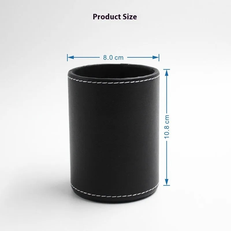 Small round black leather pen holder on a desk.