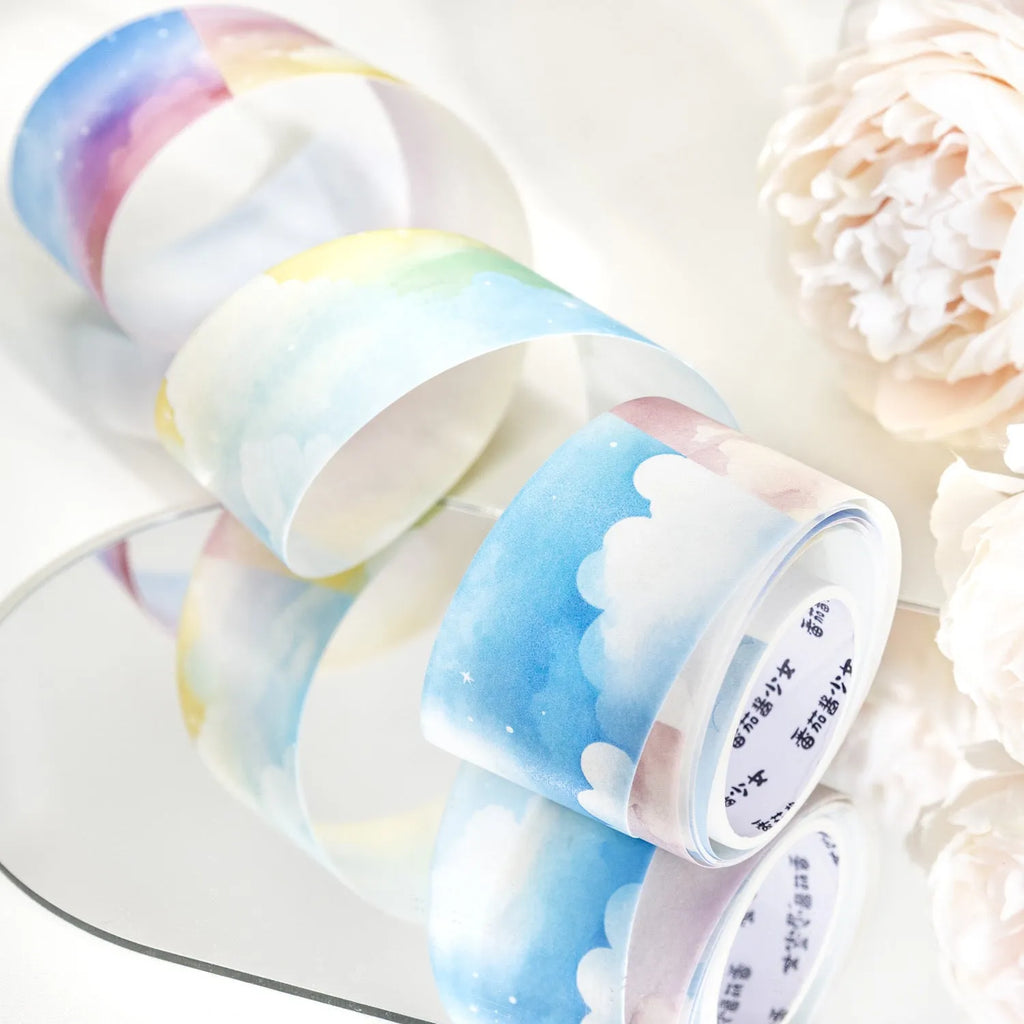 Japanese paper decorative tape roll with sky patterns including clouds, twilight and nebula designs