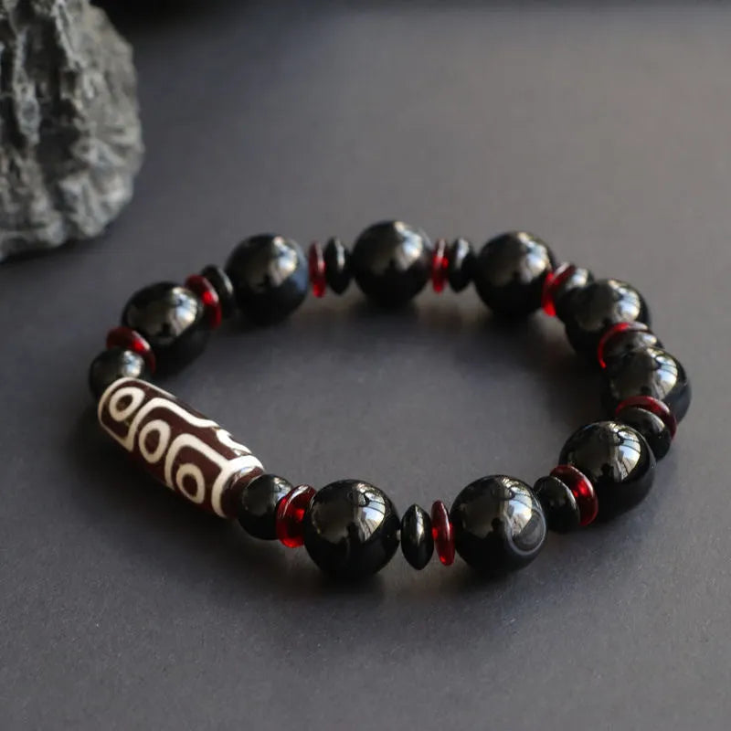 Black agate Dzi bead bracelet with hand-woven construction and 11mm geometric beads