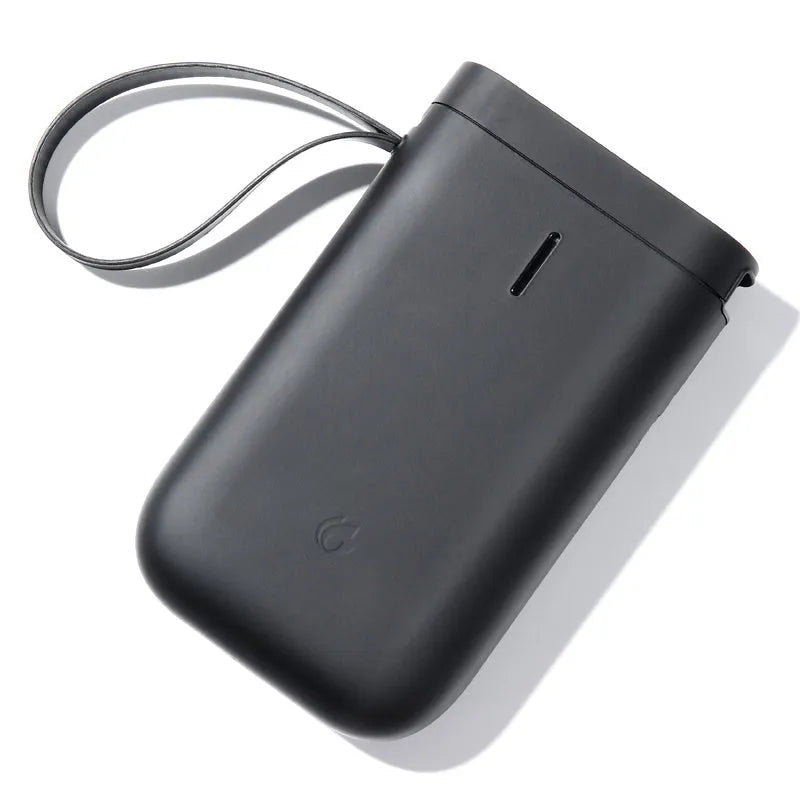 D11 Bluetooth label printer in black with thermal paper roll and smartphone showing app interface