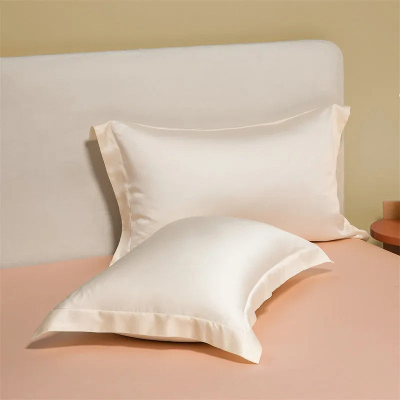 Luxury Tencel quilt cover and sheet set in Aurora Blue laid on a bed, showing deep pocket fitted sheet corner.