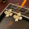 Silver Needle Metal Flower Earrings showing geometric floral pendant on long needle post in gold or silver.
