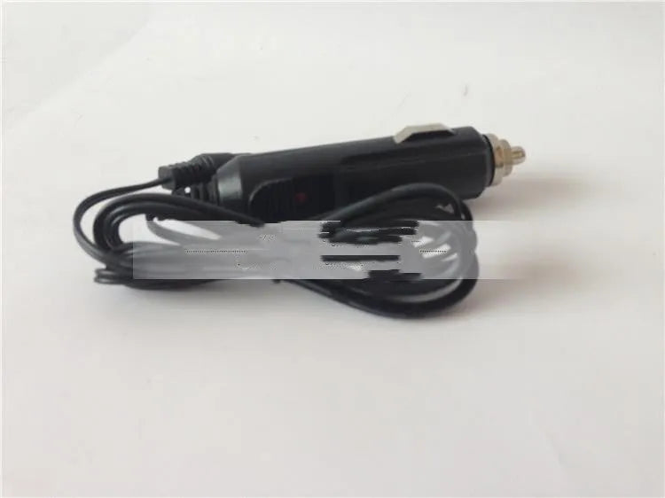 GKL112 white dual USB car charger with UK three-pin plug, shown next to a car's 12V dashboard socket.