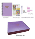 J12 purple coil-bound financial planning notebook with pen, stickers, and paper clips on a desk.