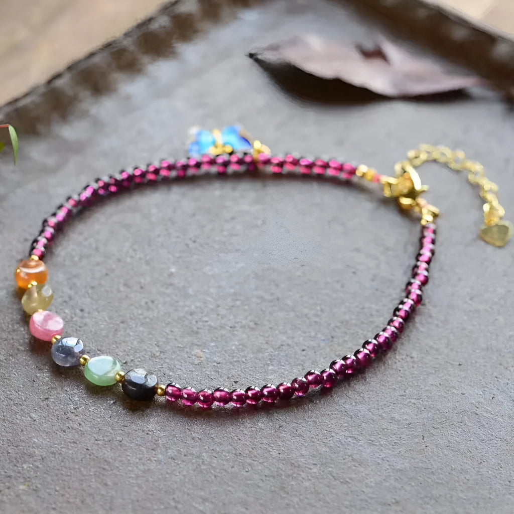 Purple garnet geometric anklet for women on an ankle.