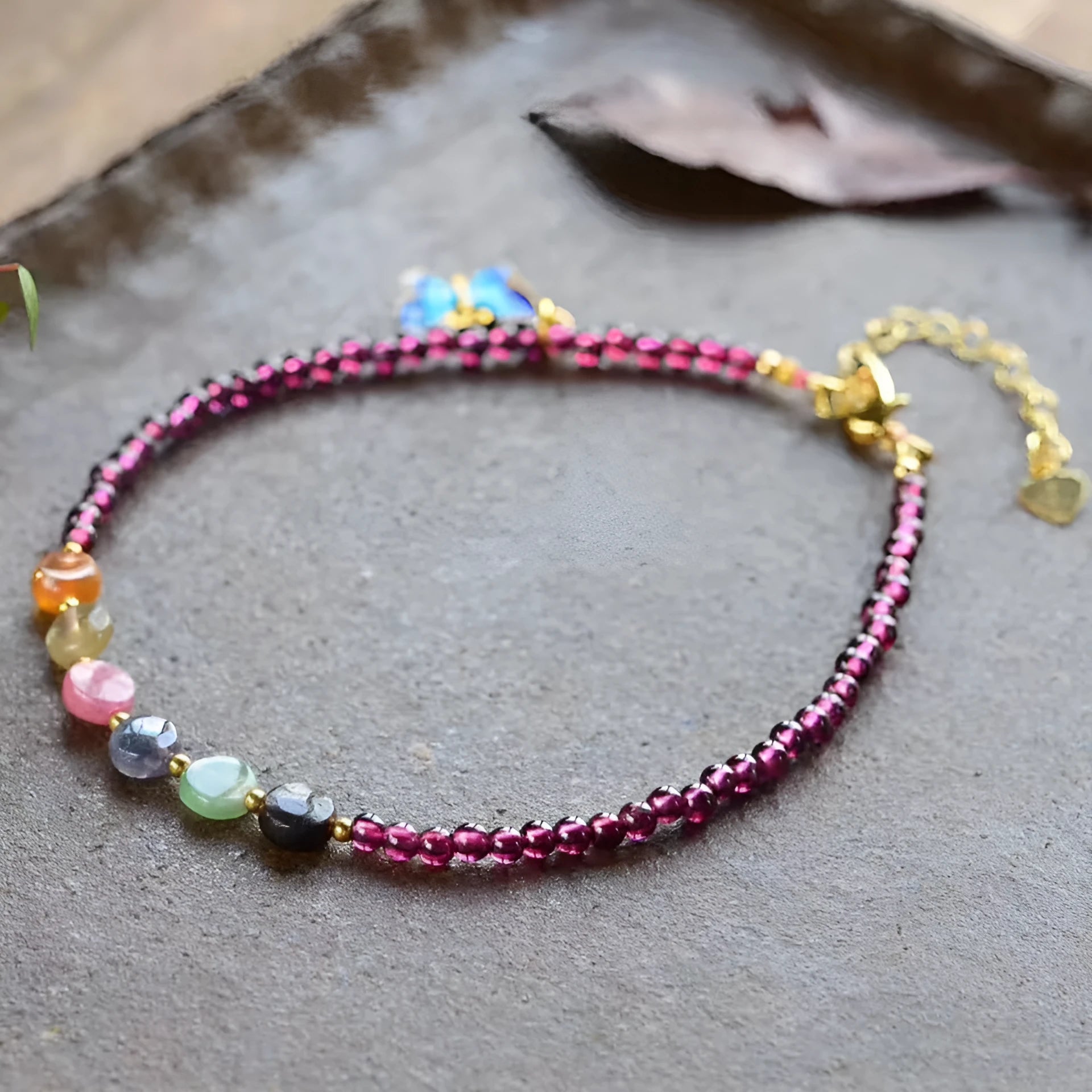 Purple garnet geometric anklet for women on an ankle.