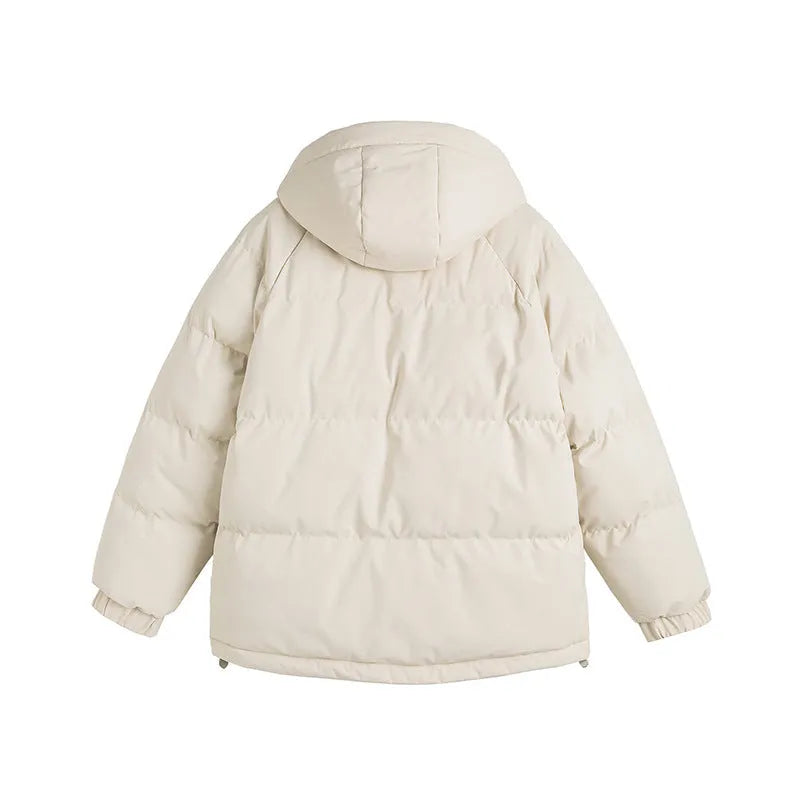 A loose, longline beige cotton-padded winter coat for men and women with side seam pockets.