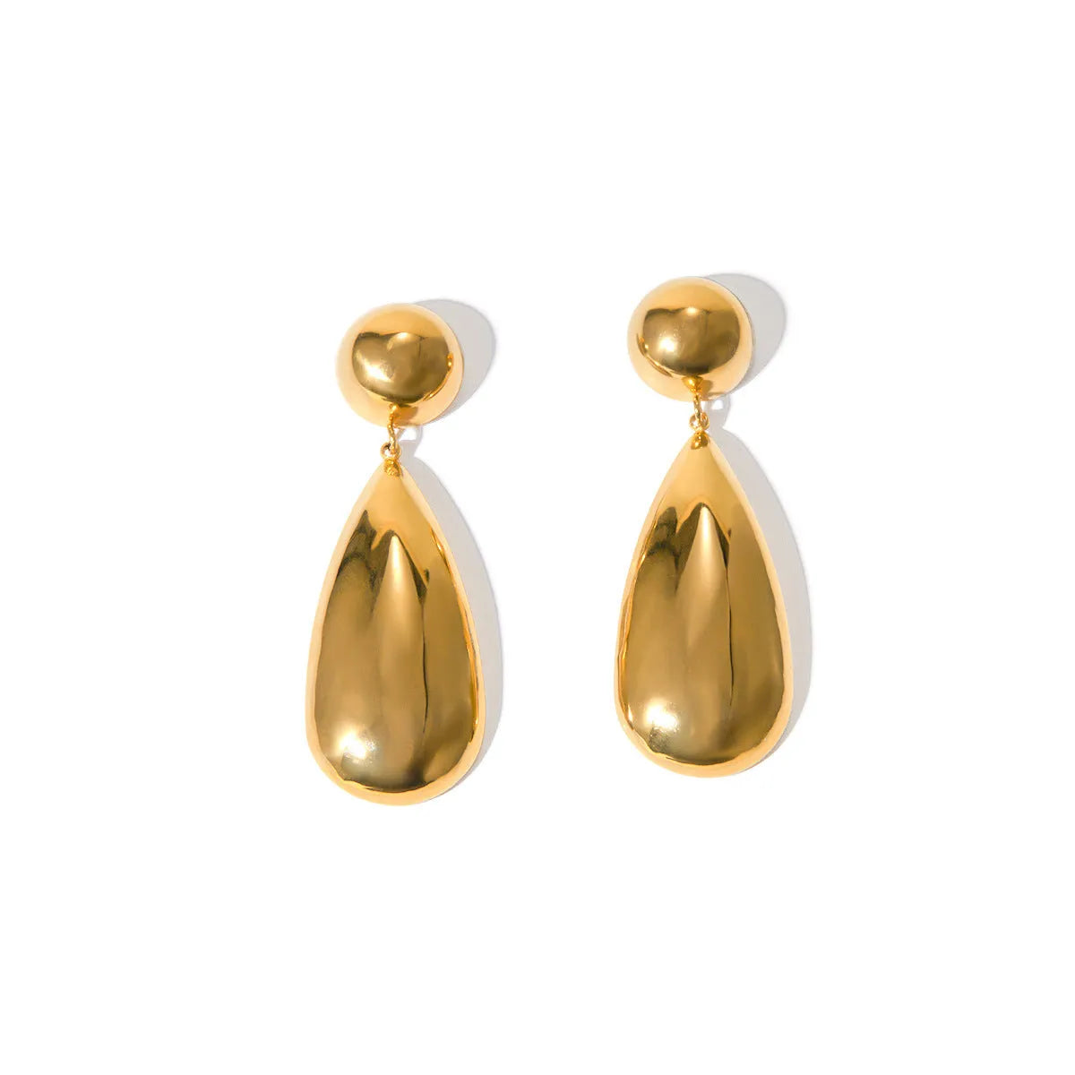 A pair of gold-coloured geometric hemisphere earrings with a hanging water droplet pendant.