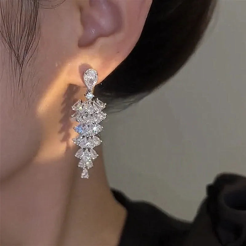 Women's silver pagoda Christmas tree drop earrings with sparkling zircon details on copper.