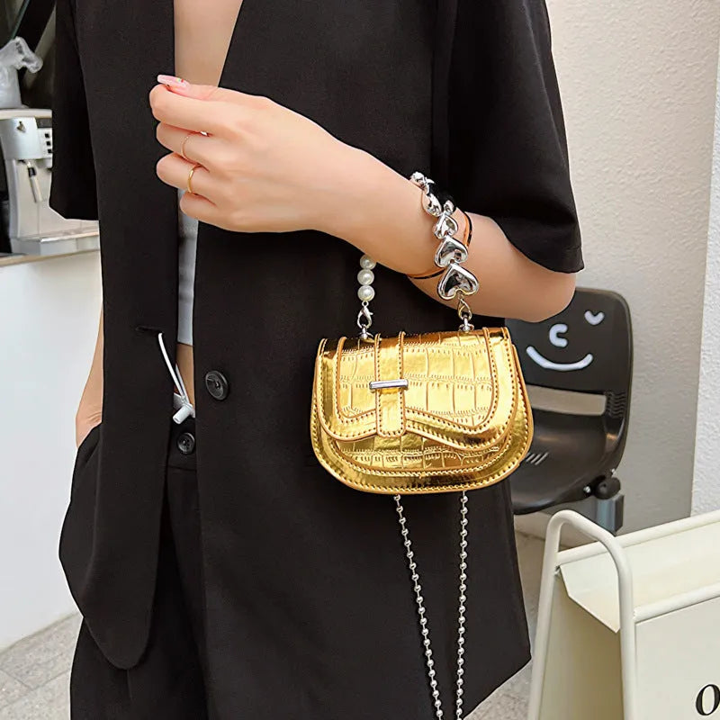 Silver women's PU leather mini saddle crossbody bag with square shape and single shoulder strap.