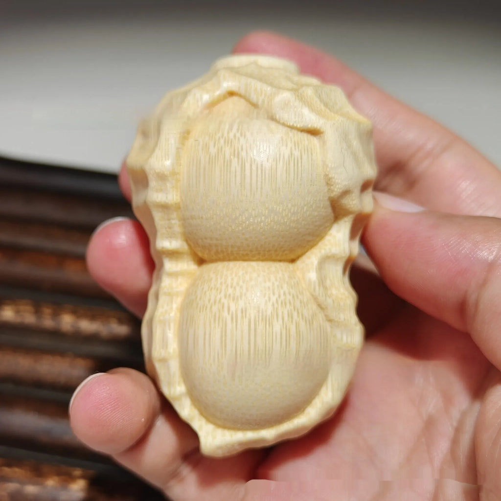 Solid bamboo carving peanut ornament on natural background