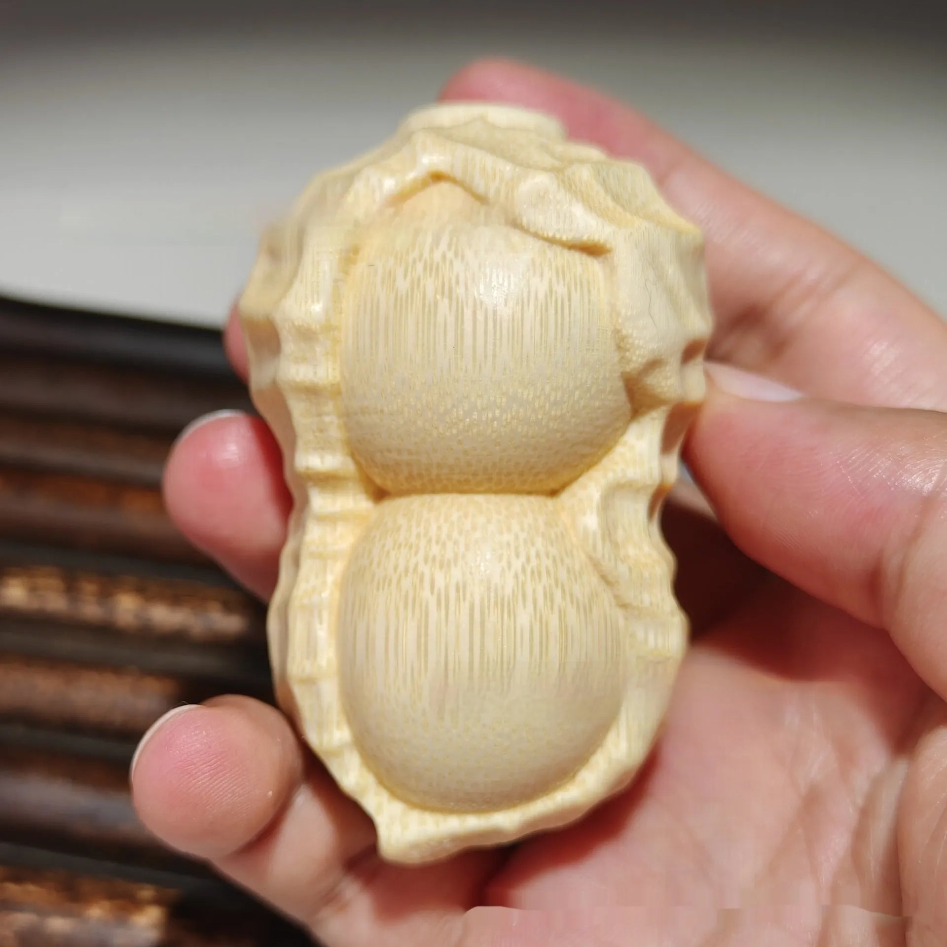Solid bamboo carving peanut ornament on natural background