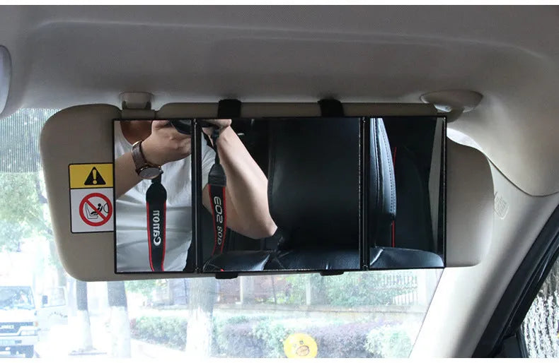 Silver folding car makeup mirror shown both closed and open on a car dashboard.