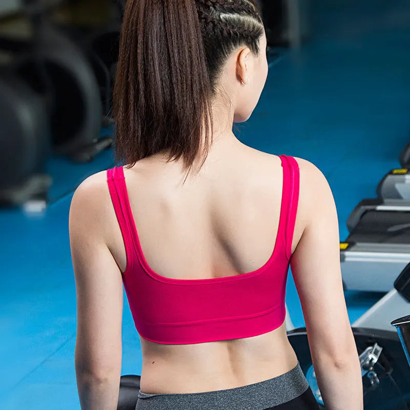 Women's reinforced sports bra in pink with thin molded cups and fixed double shoulder straps.