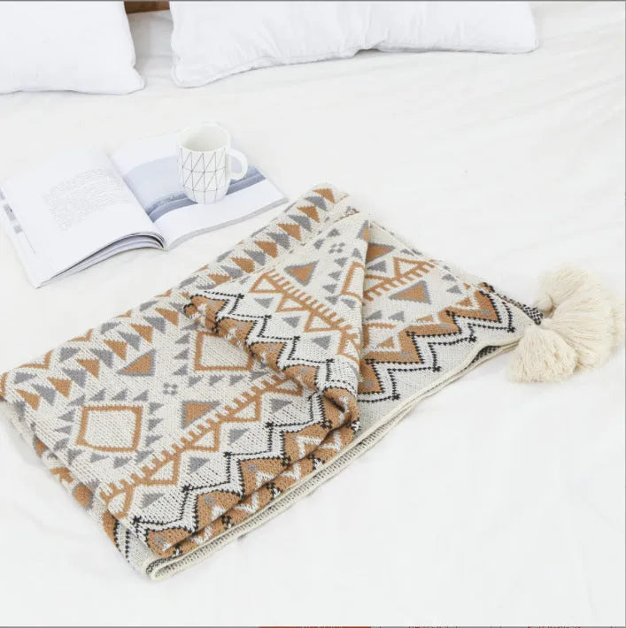Bohemian-style acrylic knit sofa blanket with tassels in a geometric pattern
