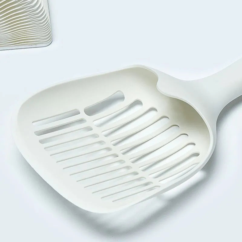 White plastic cat litter scoop with base on a clean surface, 29.5x12.8cm