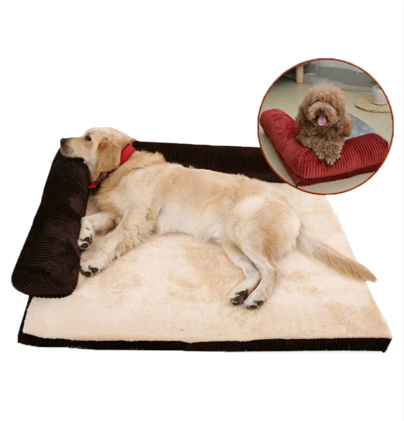 A corduroy dog sofa bed with a raised bolster side, shown in a grey colour on a wooden floor.