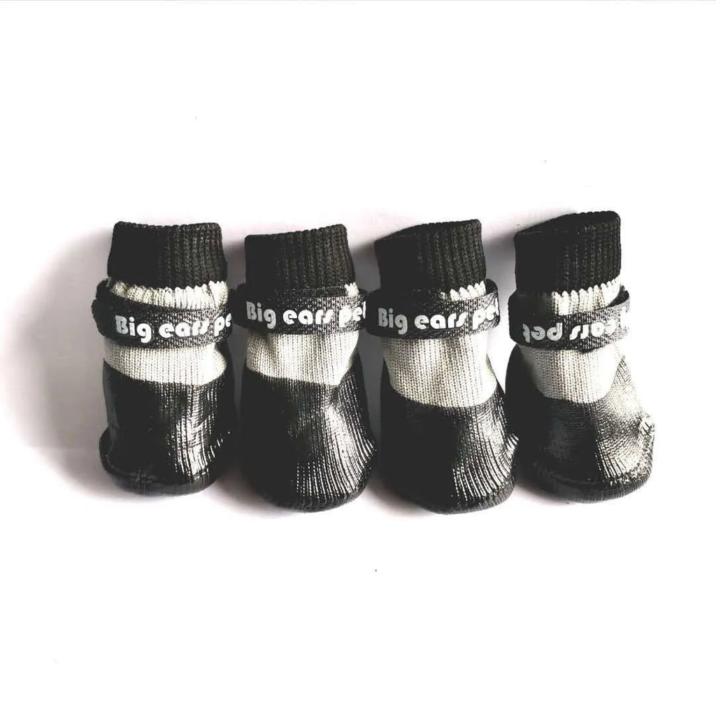 Pet dog soft bottom anti-scratch shoe cover in black on a light-coloured floor showing non-slip sole