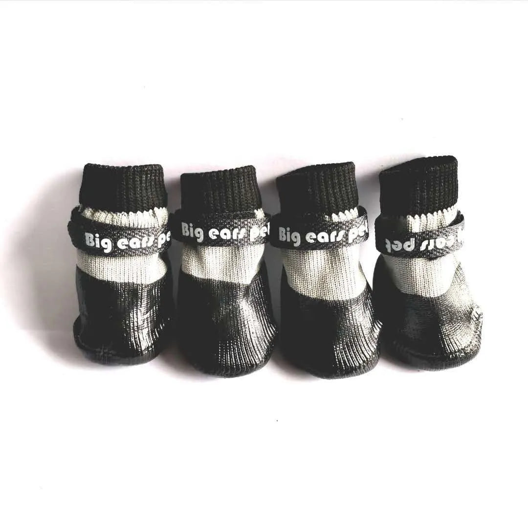 Pet dog soft bottom anti-scratch shoe cover in black on a light-coloured floor showing non-slip sole