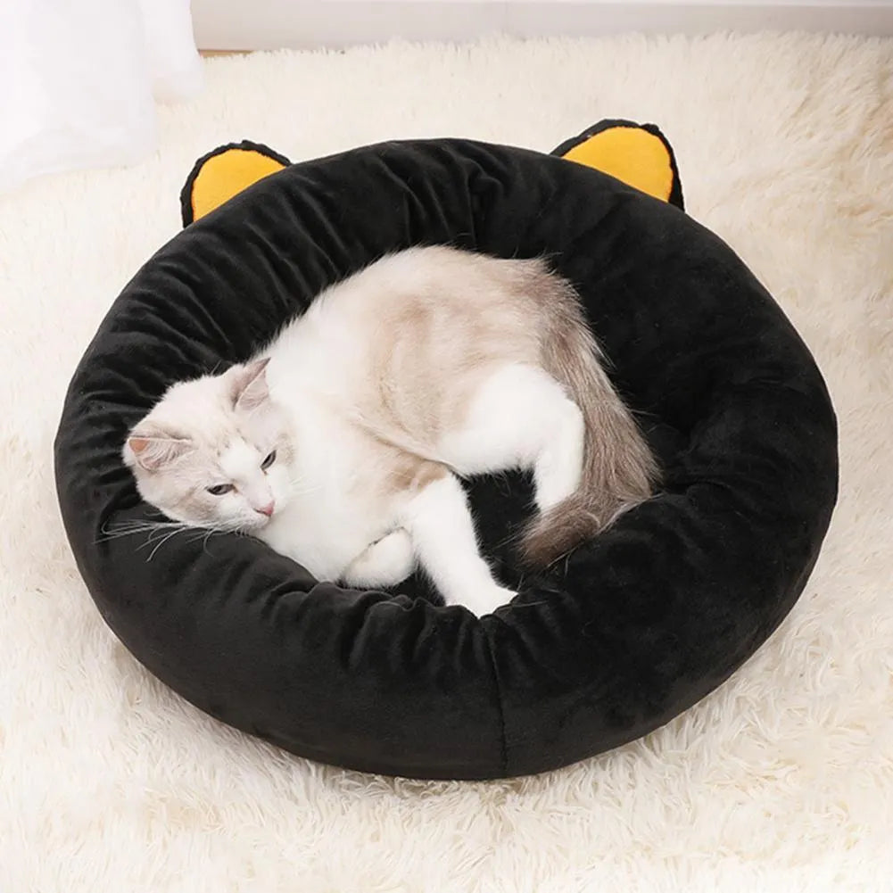 Black cat-shaped velvet pet bed with raised edges for head support in two size options