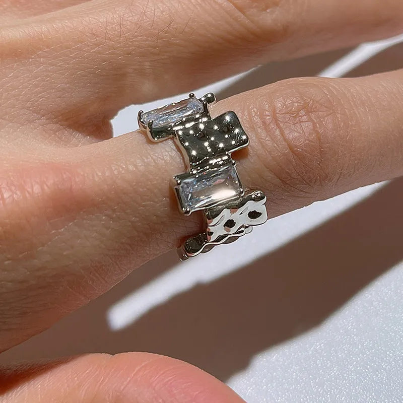 Silver cross ring with geometric design and open gemstone setting