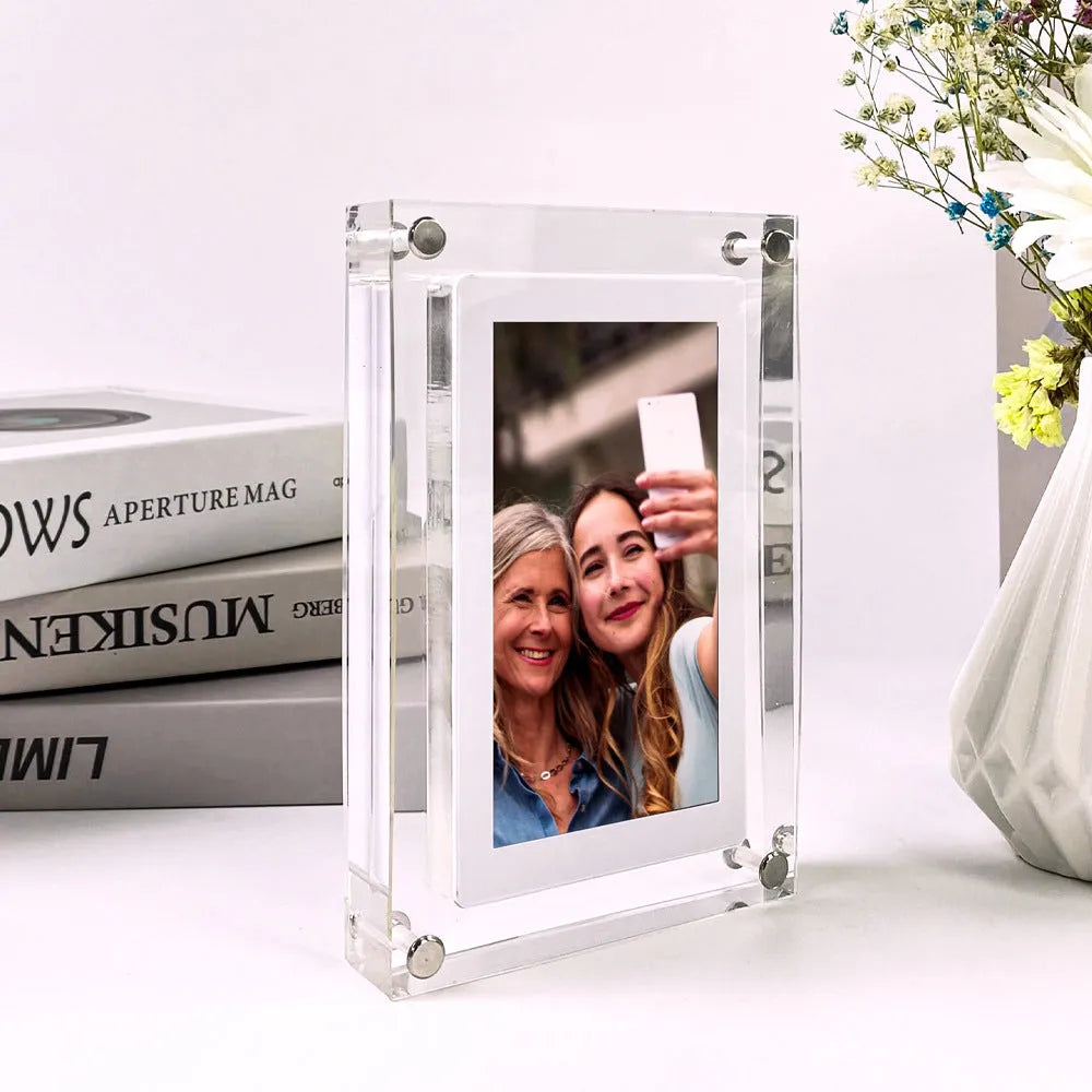White vertical digital picture frame with 5-inch screen on a table