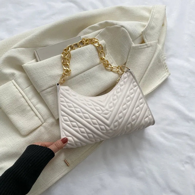 A structured black pleated women's shoulder bag with a chain strap and a soft handle, showing its square shape.