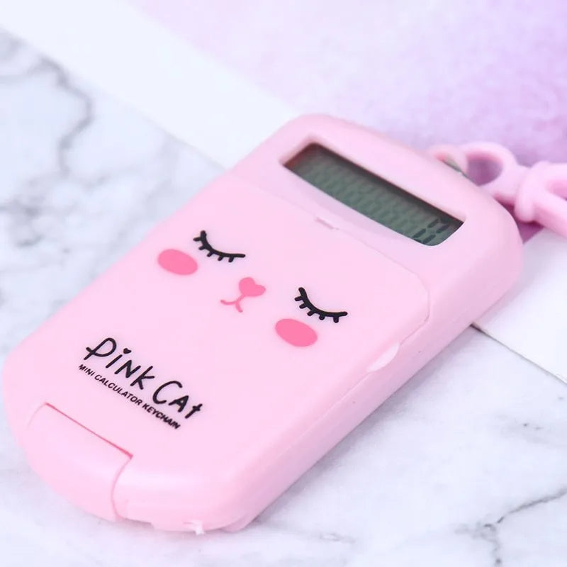 Creative cookie-shaped cute mini calculator in pink with key ring on a white background