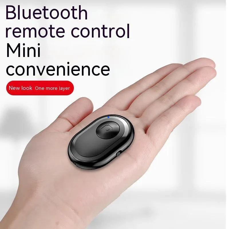 Wireless Bluetooth self-timer remote control in black, pink, and purple colours next to a smartphone.