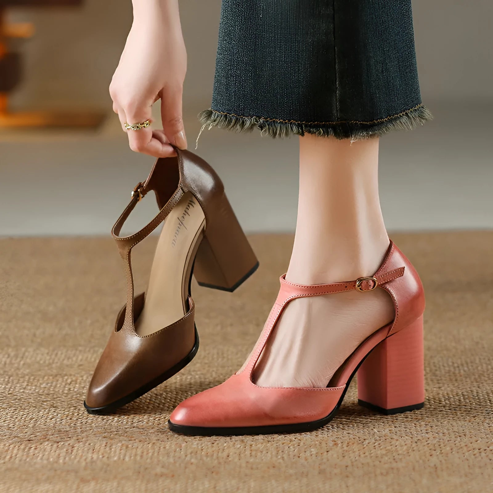 Women's pink and dark brown retro Mary Jane shoes with a pointed toe, buckle, and hollow design detail.