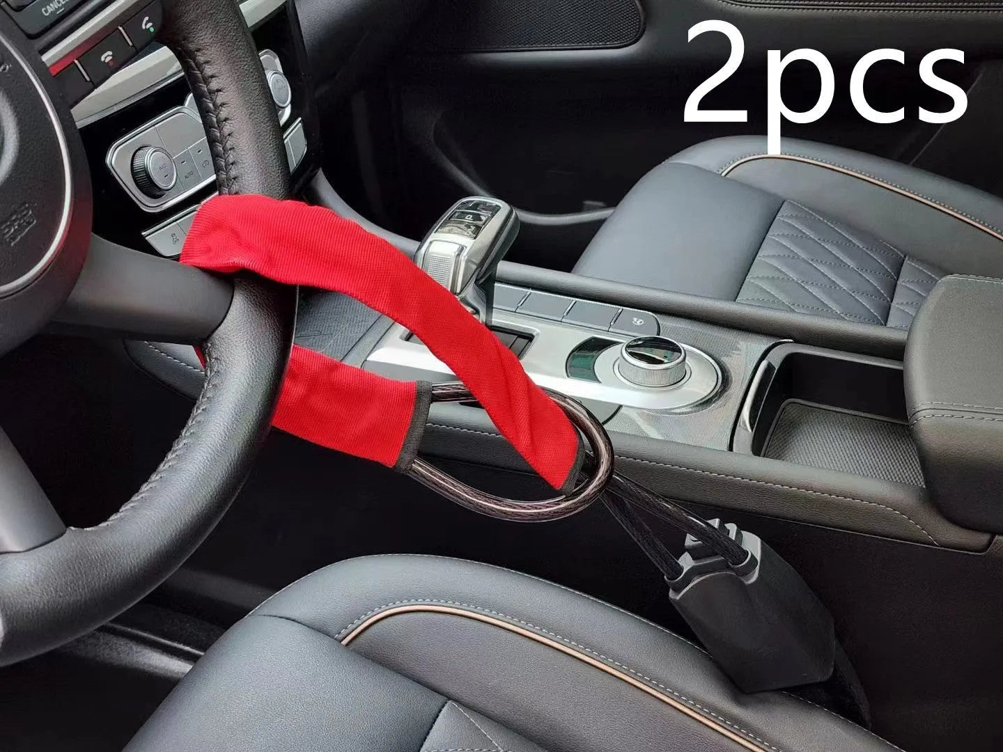 Red steel car steering wheel security lock with coiled cable on a car seat.